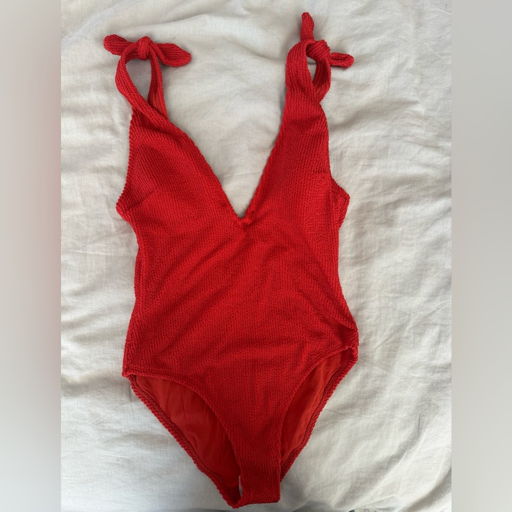 Orange one piece swimming suit. Brand new